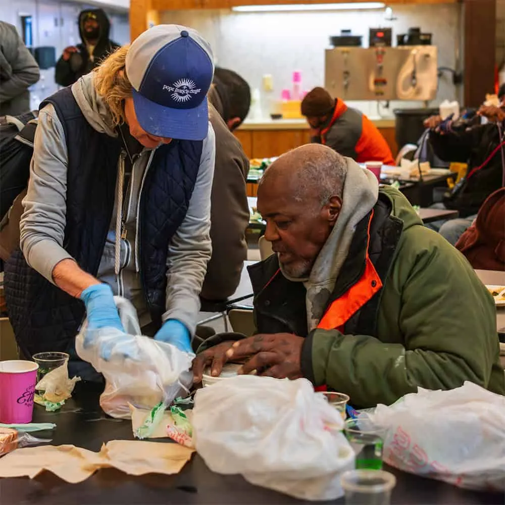 volunteer with guest at PFC Day Center