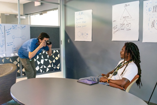 Staff taking photo of Bridge Housing Campus resident